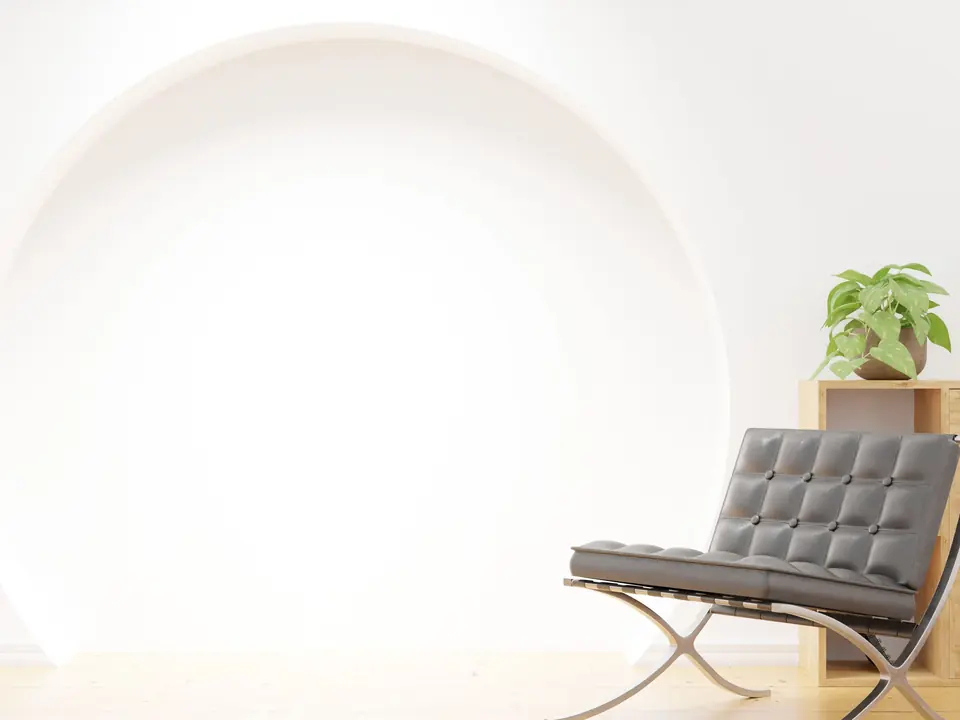 Sala blanca con butaca de diseño y luz natural